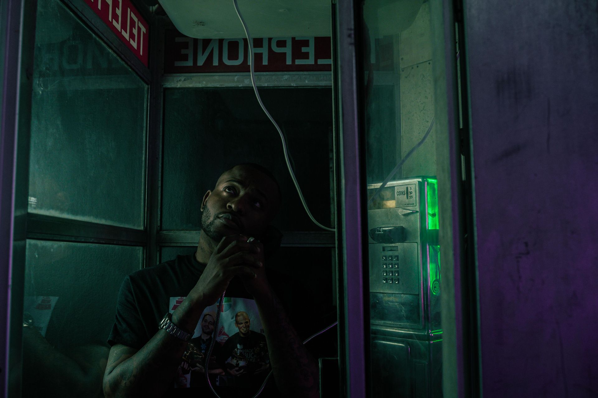 A Man using a Telephone in a Telephone Booth