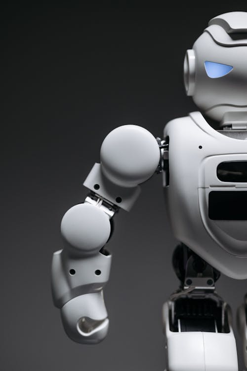 White Robot Toy in Close Up Photography