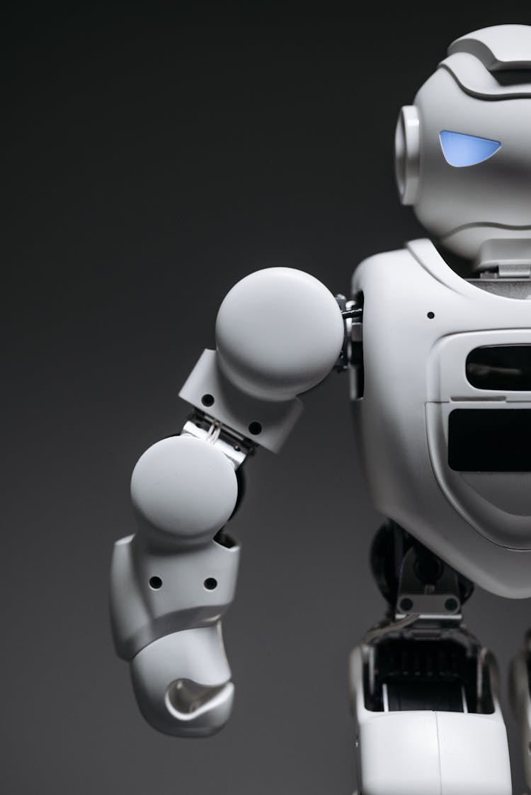 White Robot Toy In Close Up Photography