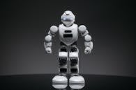 A Close-up Shot of a White Robot Toy with Lighted Eyes