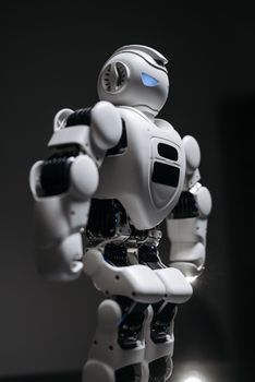 A detailed studio shot of a humanoid robot against a gray background, showcasing modern technology.