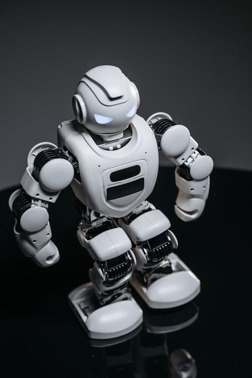 Free A Close-up Shot of a White Robot Toy with Lighted Eyes Stock Photo