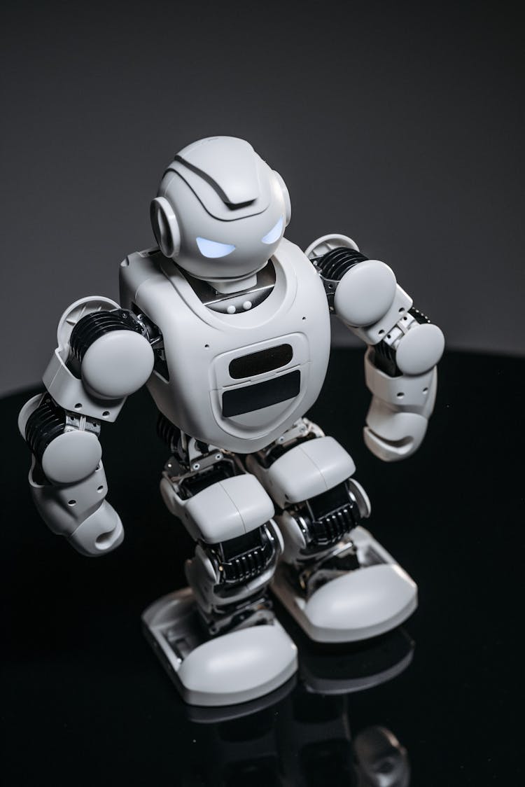 A Close-up Shot Of A White Robot Toy With Lighted Eyes