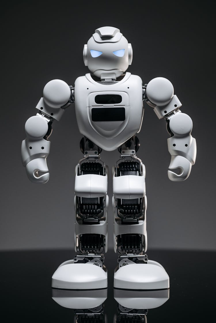 A Close-up Shot Of A White Robot Toy With Lighted Eyes