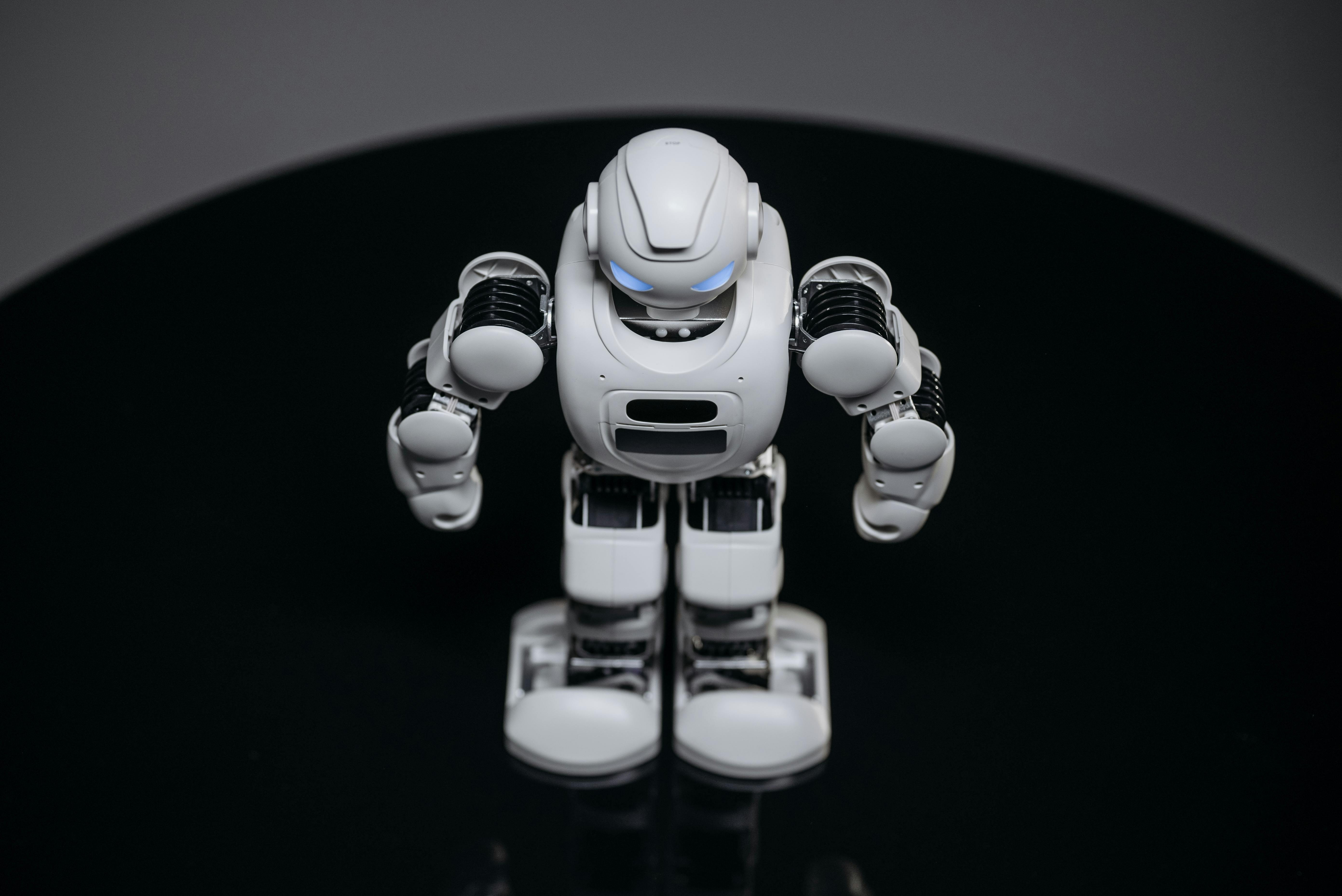 white robot toy on black surface