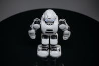 White Robot Toy on Black Surface