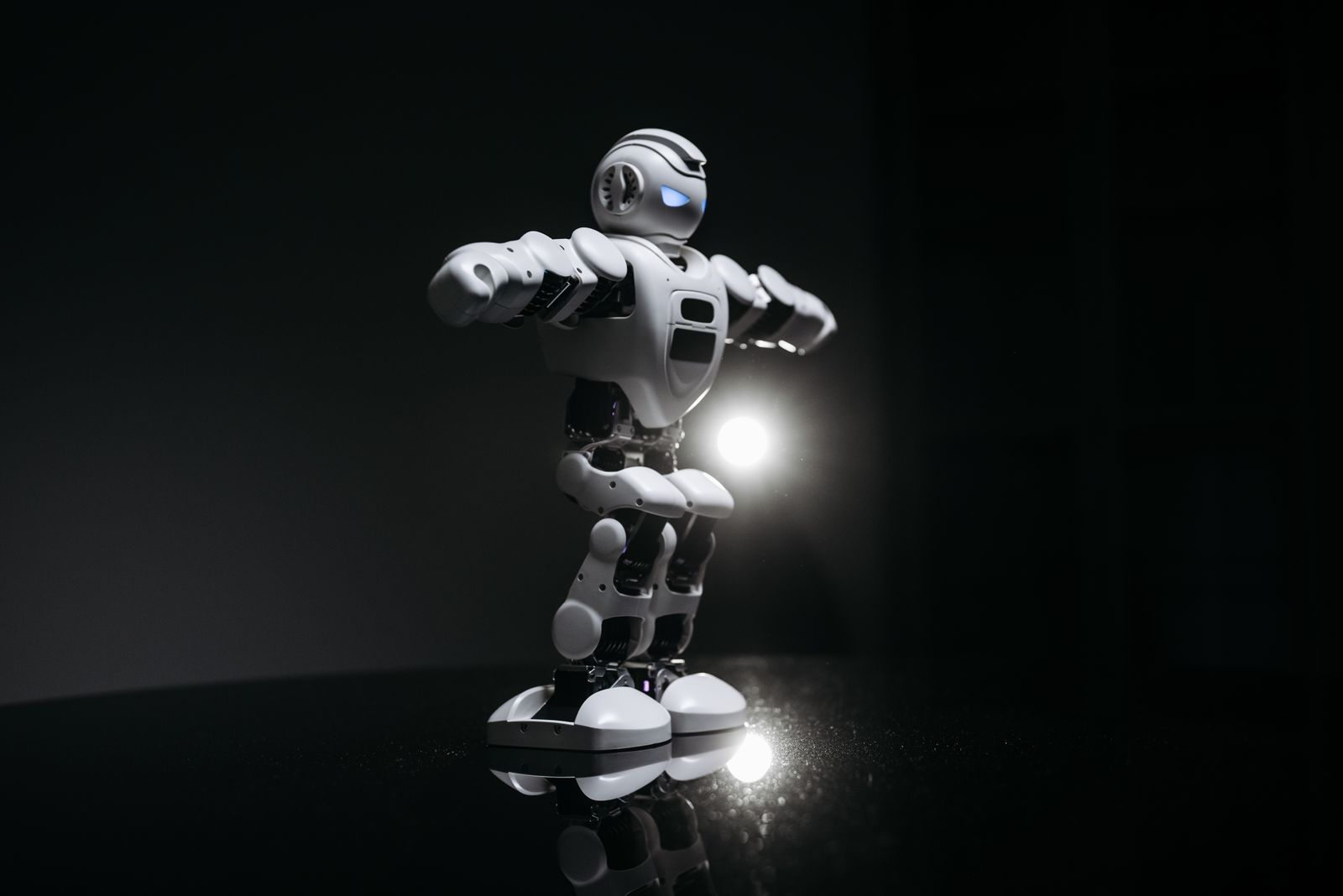 Humanoid robot in dark studio lighting