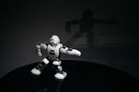 White Robot Toy on Black Surface