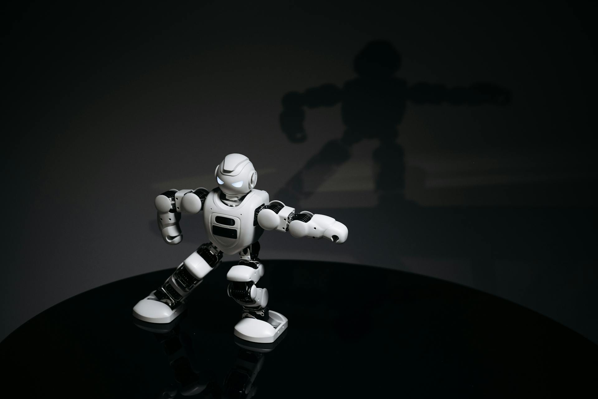 White Robot Toy on Black Surface