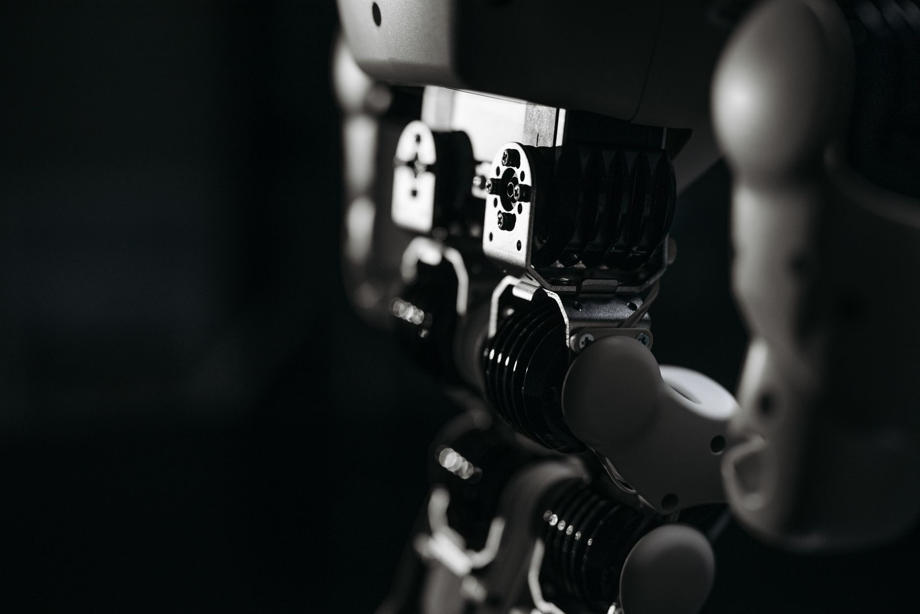 Detailed close-up of a robot's mechanical components, emphasized by moody studio lighting.