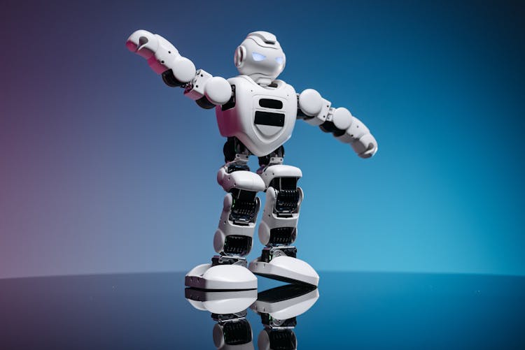 White Toy Robot On Blue Background