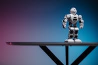 White Robot on Black Metal Bar