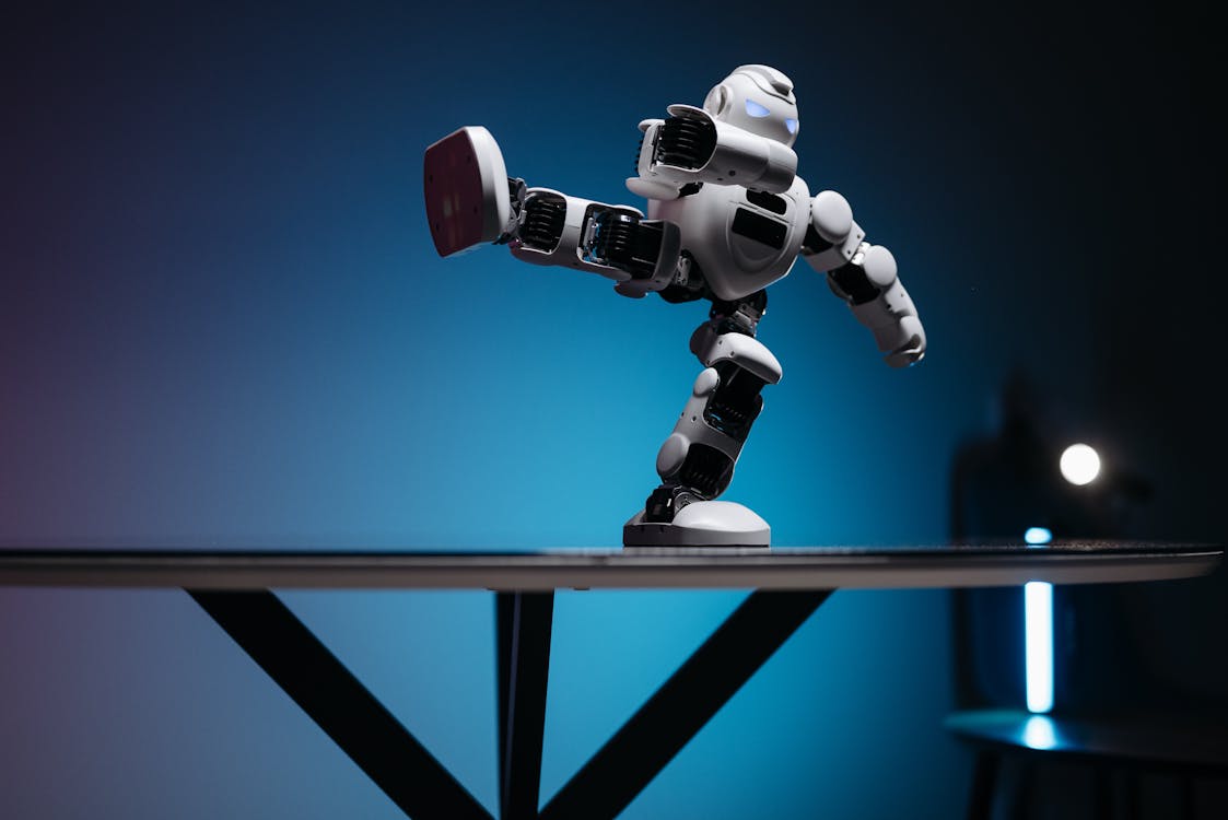 Free A White Robot with Leg Raised Sideways Stock Photo