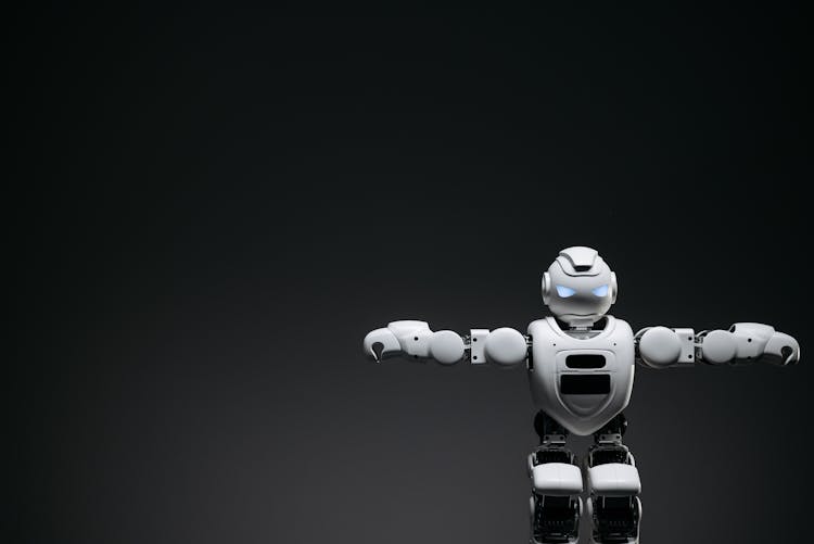 White Toy Robot In Black Background