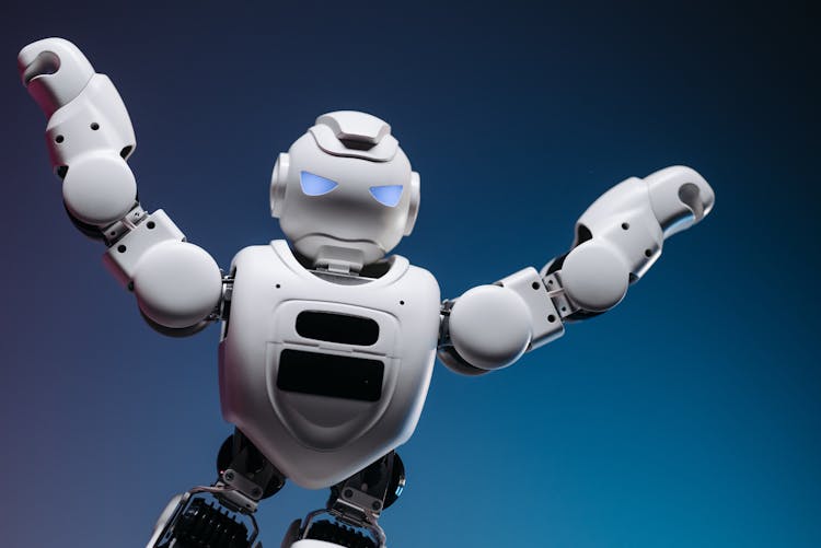 White Toy Robot On Blue Background