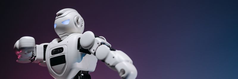 Close-up of a futuristic robotic toy against a gradient background, symbolizing innovation and technology.