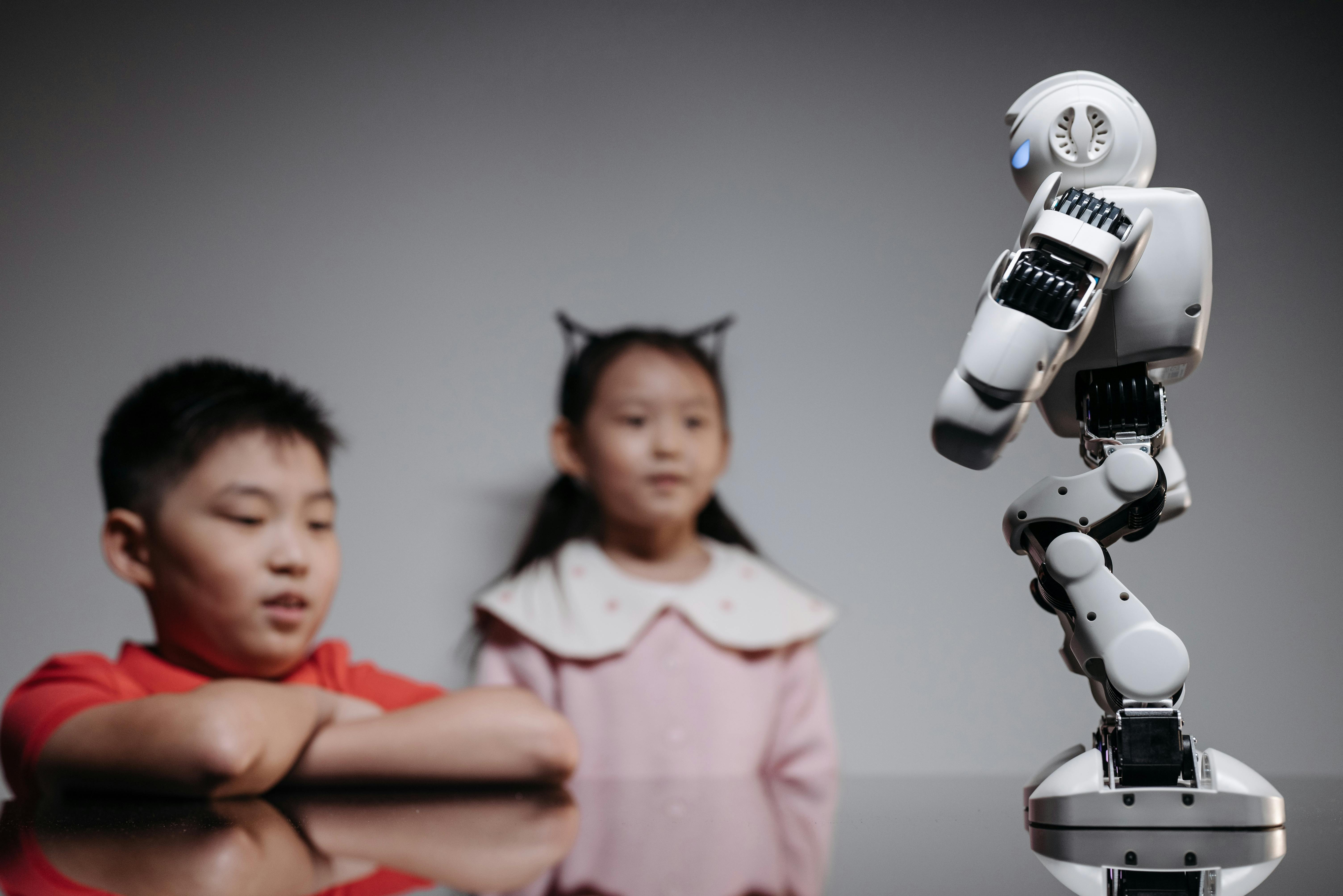 kids looking at white toy robot on the table