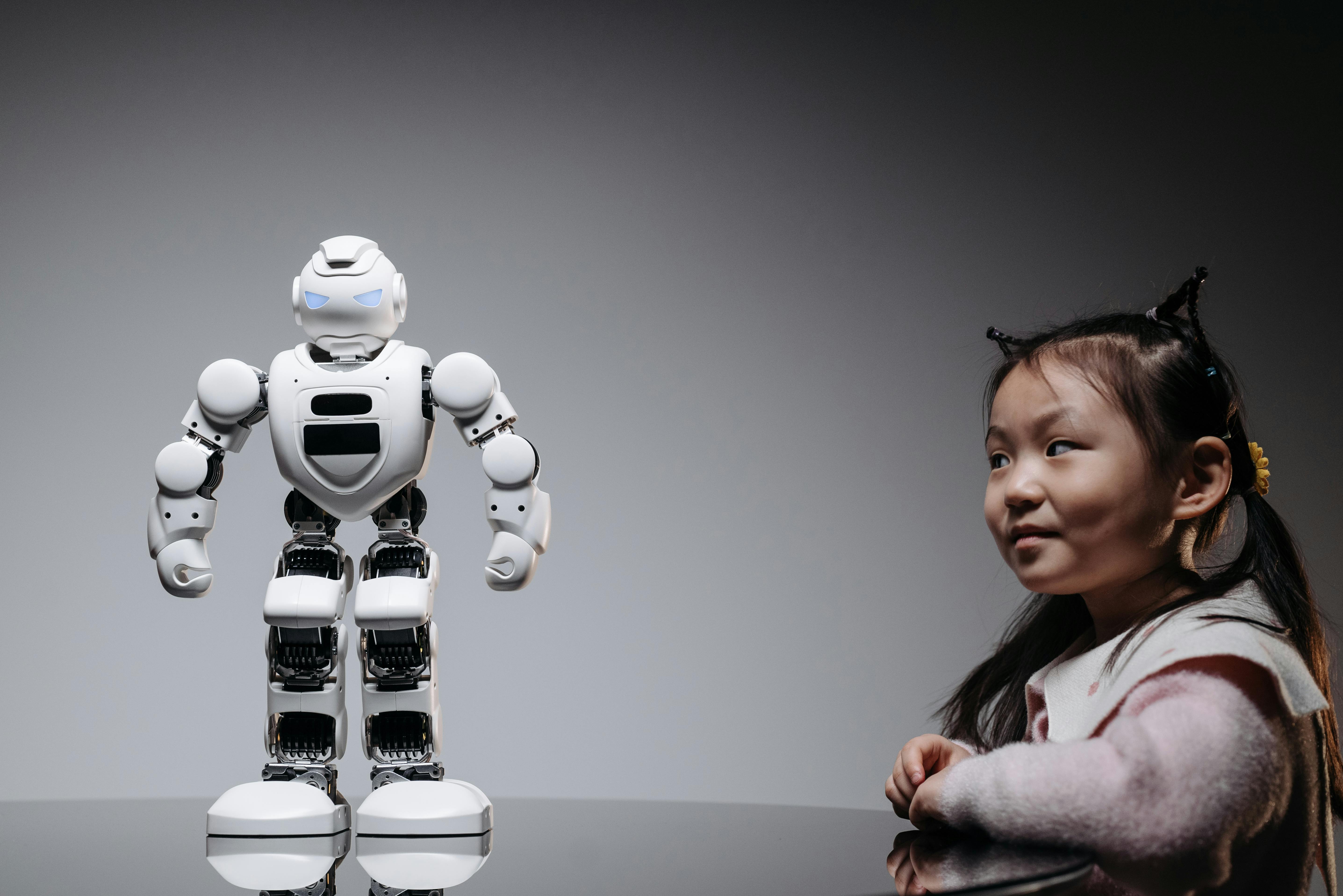 a girl looking at the white toy robot