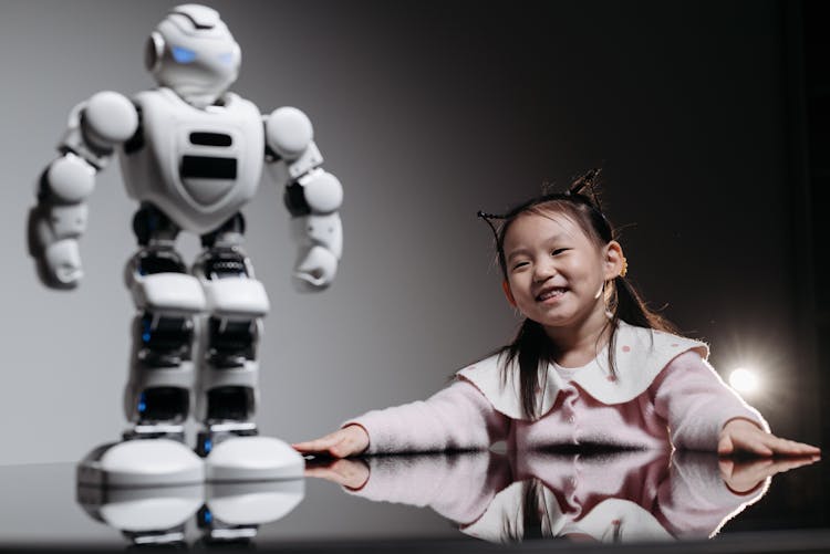 A Girl Looking At The White Toy Robot