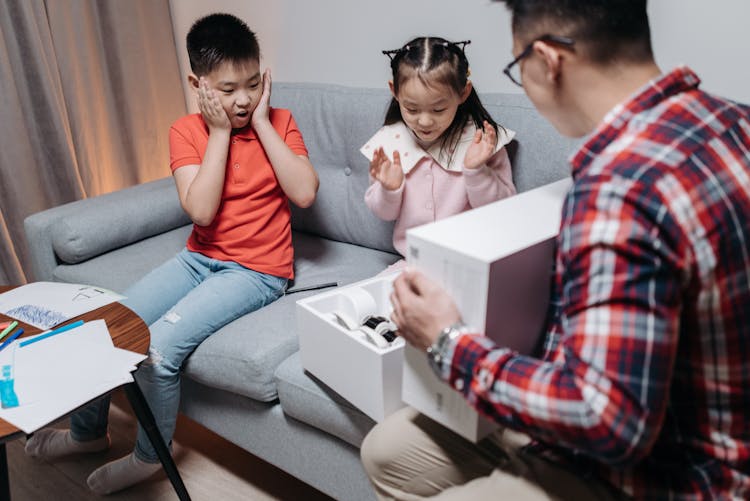 Kids Amazed By The Present On The White Box