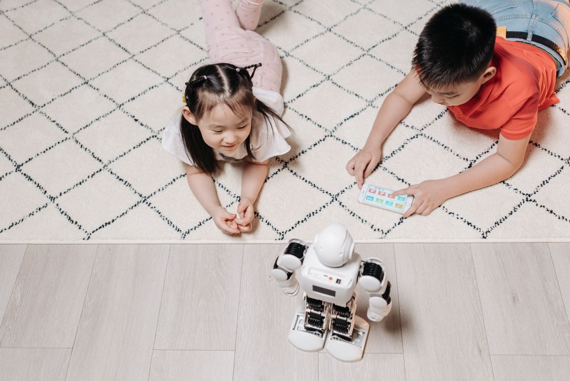 Kids Lying on the Floor while Looking at the Robot · Free Stock Photo