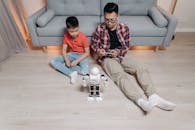 A Father Controlling a Robot with His Cellphone