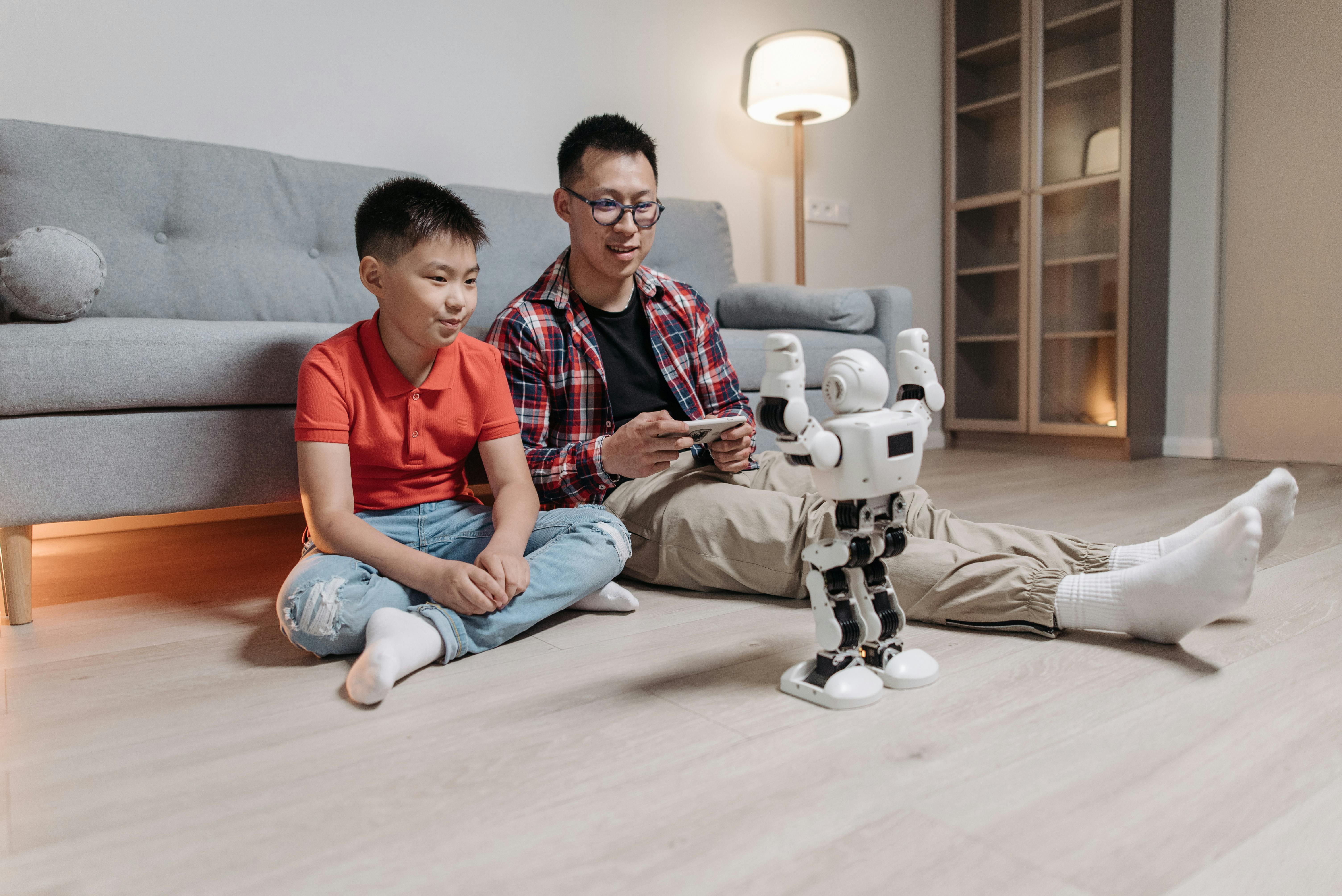 a man showing his kid how to control the robot