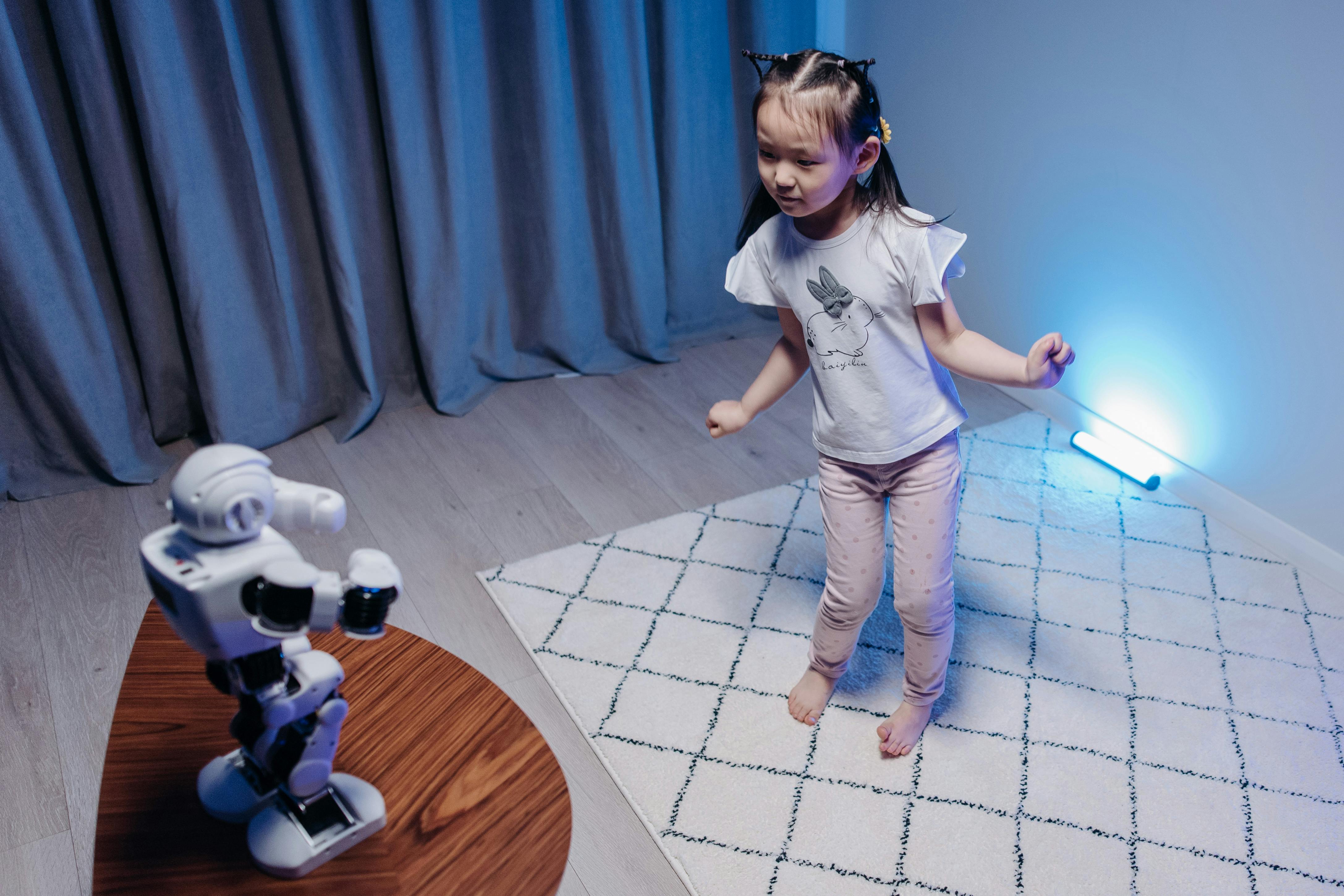 a girl looking at the robot dancing on a wooden table