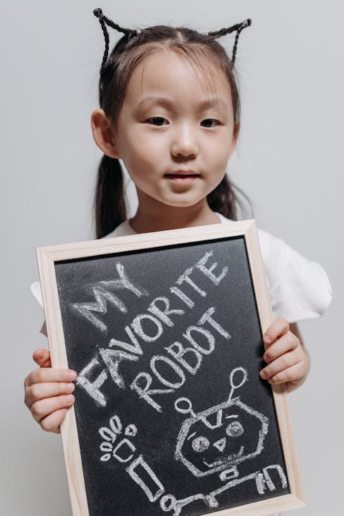 A Cute Little Girl Holding a Small Blackboard