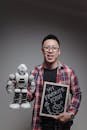A Man Holding a Robot Toy