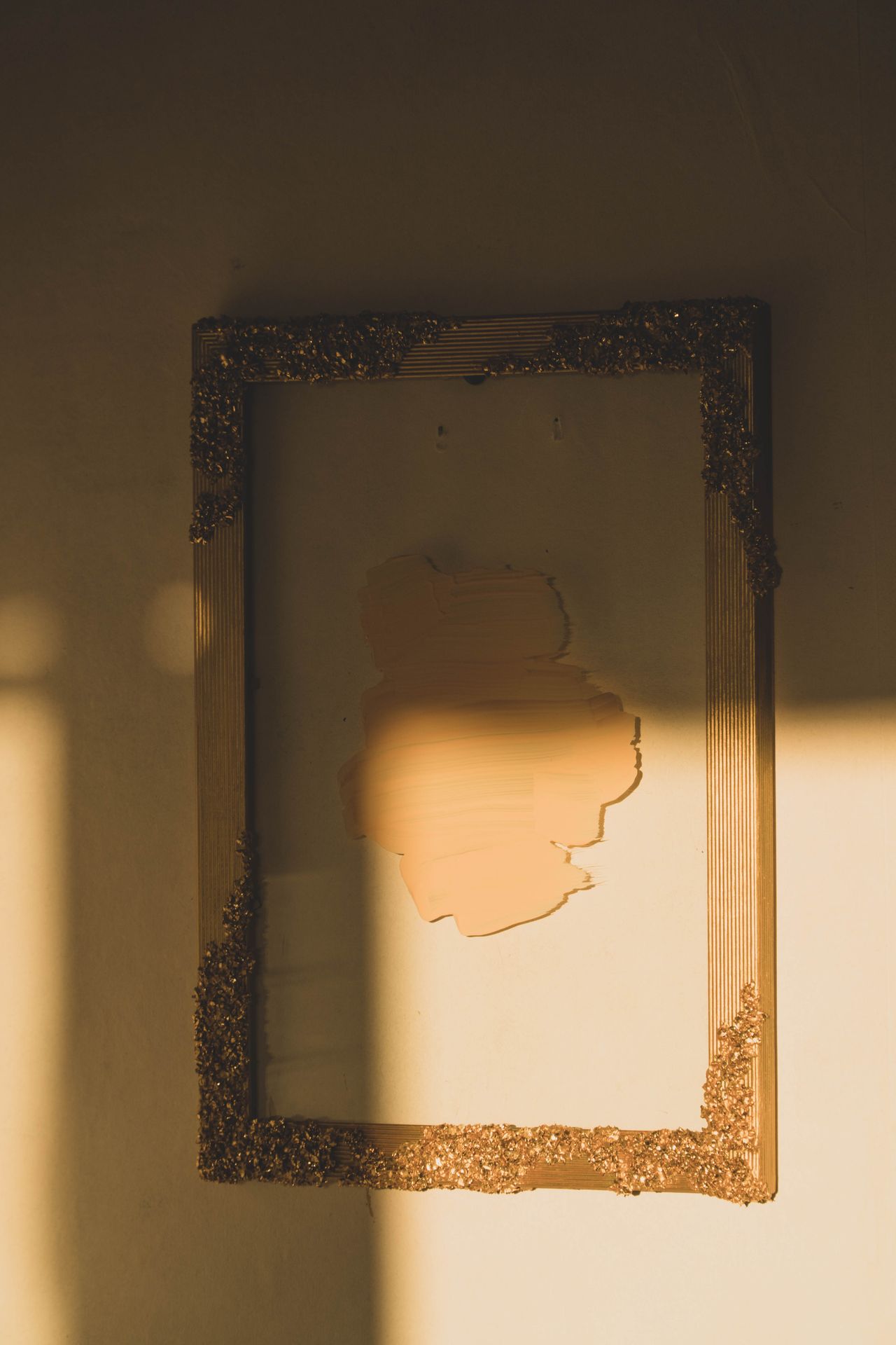An empty wooden frame on a white wall as a layout placeholder