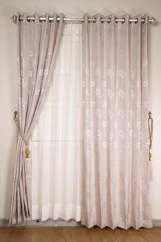 Stylish pink curtains enhance a minimalist interior, offering elegance and soft ambiance.