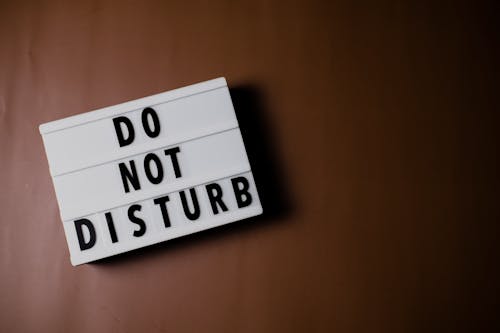 Do Not Disturb Text on Brown Surface