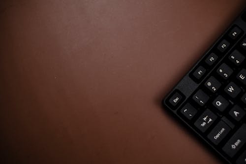 Keyboard On a Brown Surface