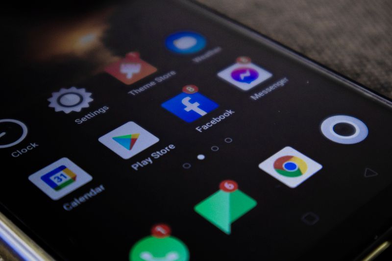 Smartphone screen with popular app icons including Facebook and Messenger
