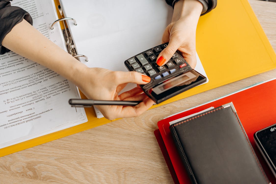 Free A Woman Computing with a Calculator Stock Photo