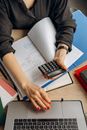 Person Holding Black Calculator While Using Laptop