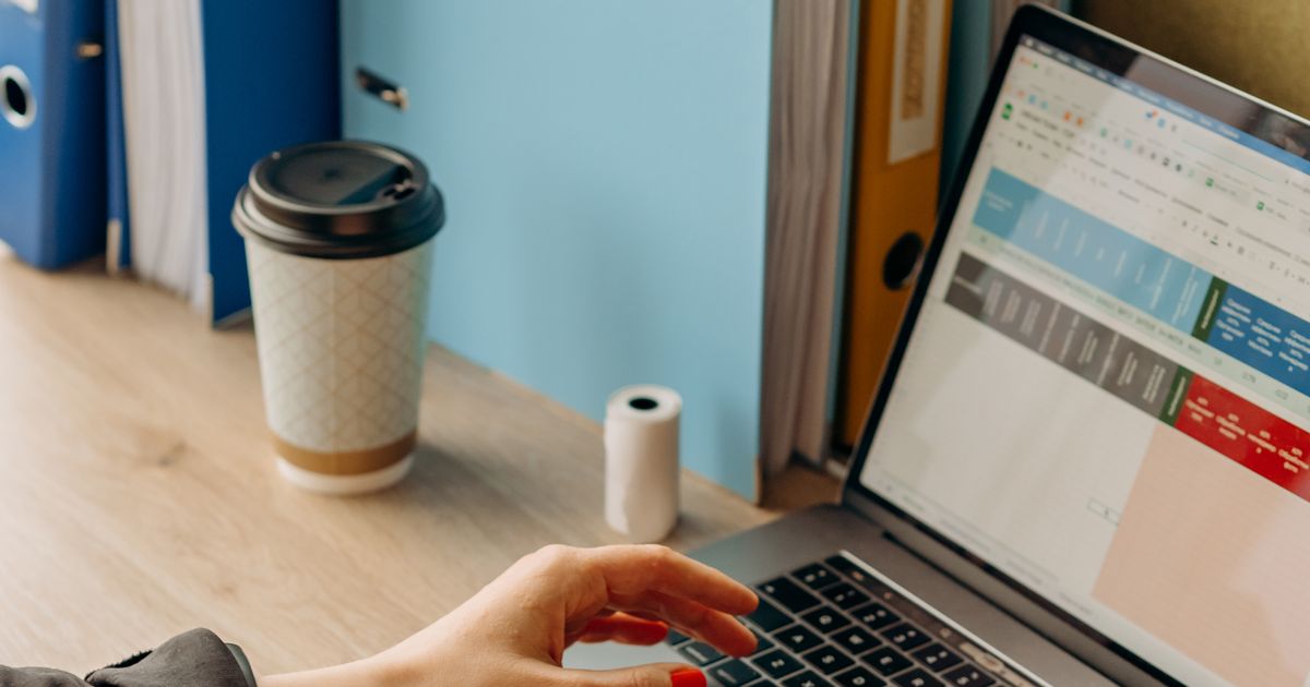 Professional writing an email at their desk