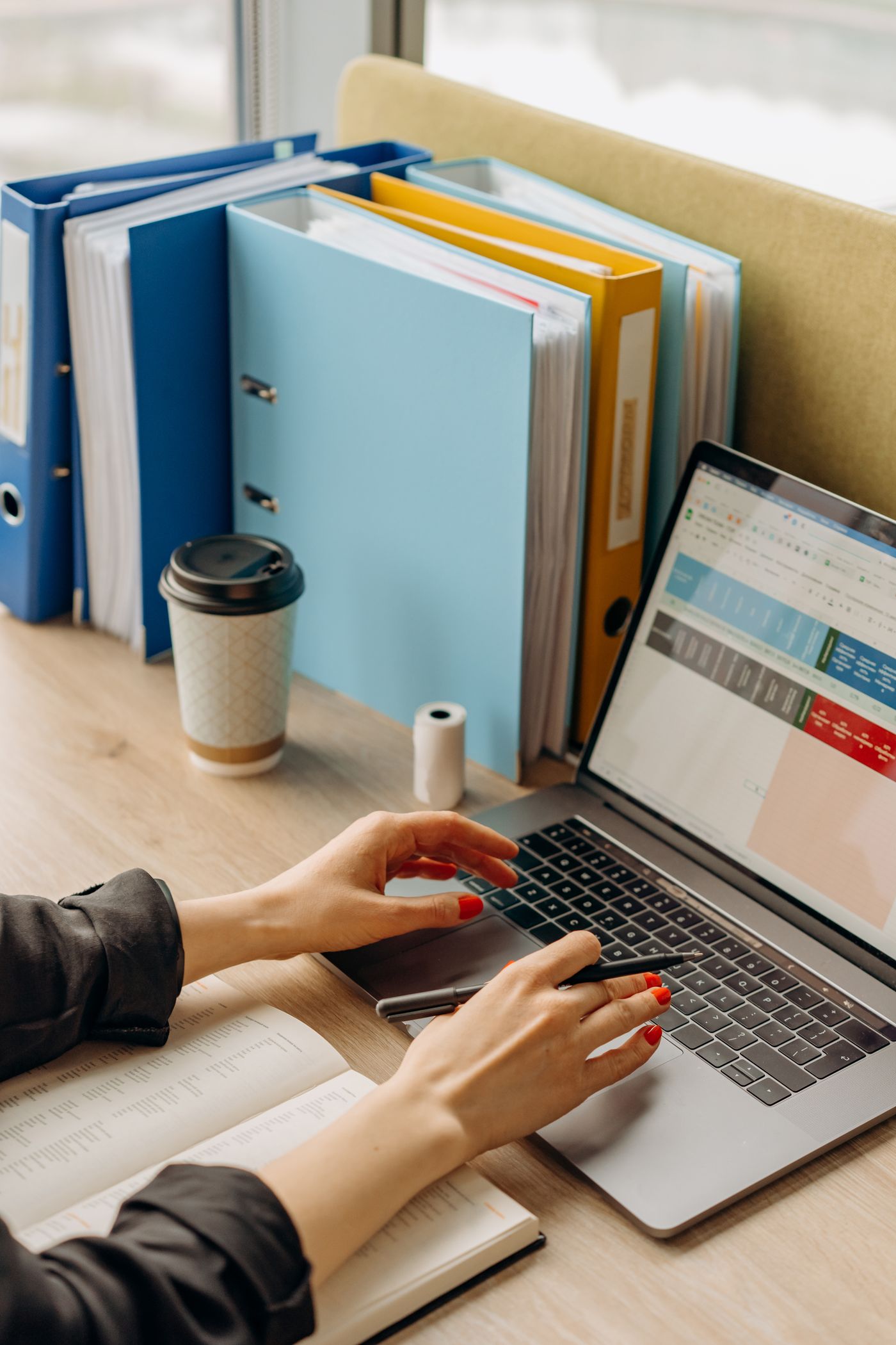 Organised digital workplace with laptop and documents