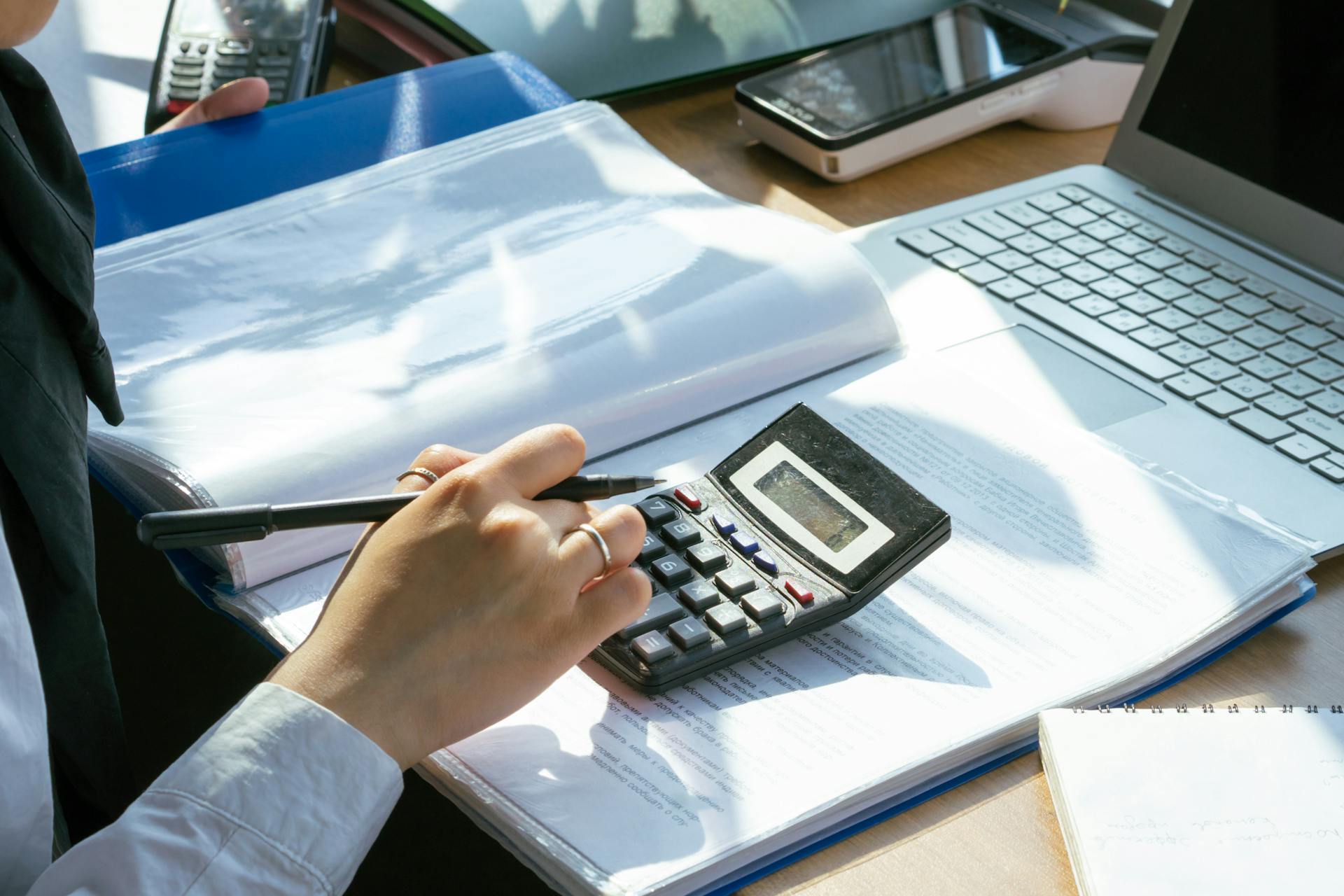 A Person Using a Calculator