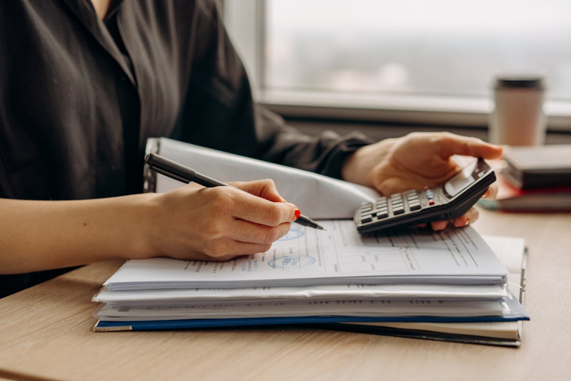 A person holding a calculator while working