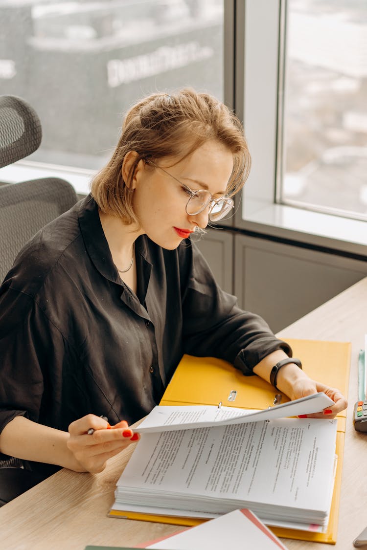 A Woman Reading The Documents