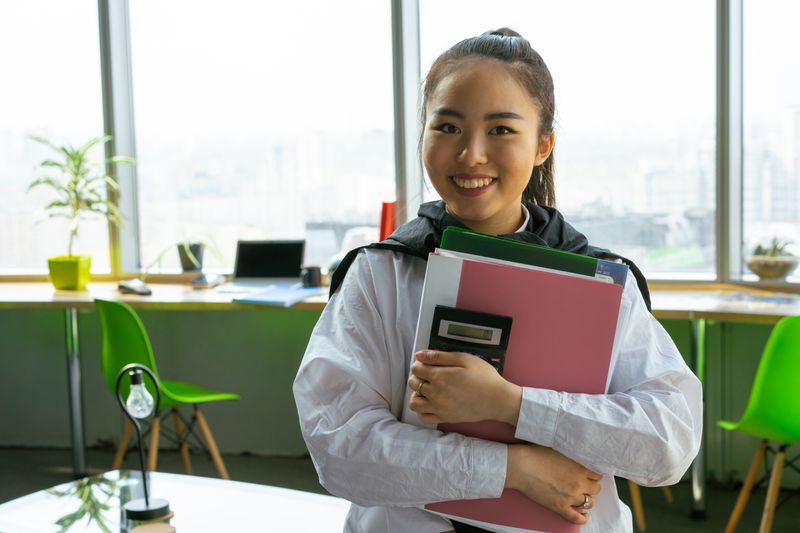 intern organizing folders at a desk