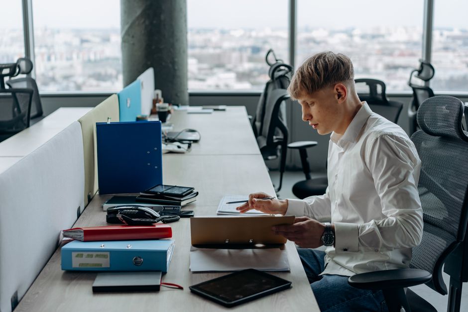 Young professional working diligently in a bright, modern office setting.