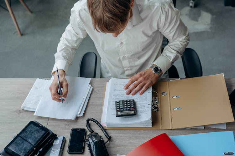 A Man Using A Calculator