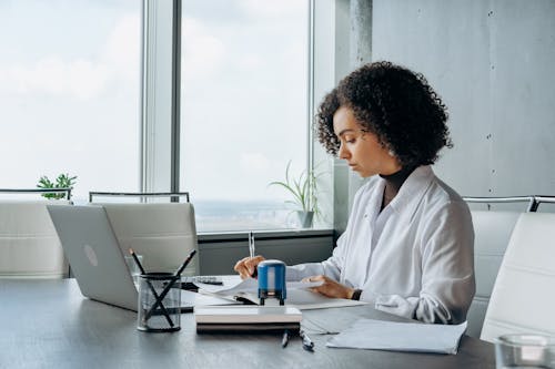 Free A Woman Sitting in the Office Stock Photo
