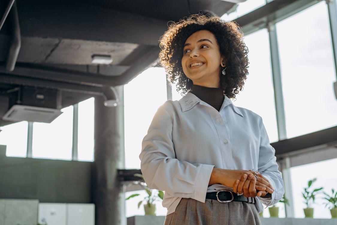 A Woman In White Long Sleeves Working in an Office · Free Stock Photo