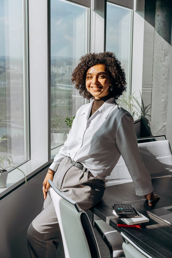 woman wearing turtleneck and bootcut trousers office