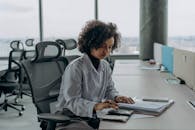 Woman Sitting at Table Working