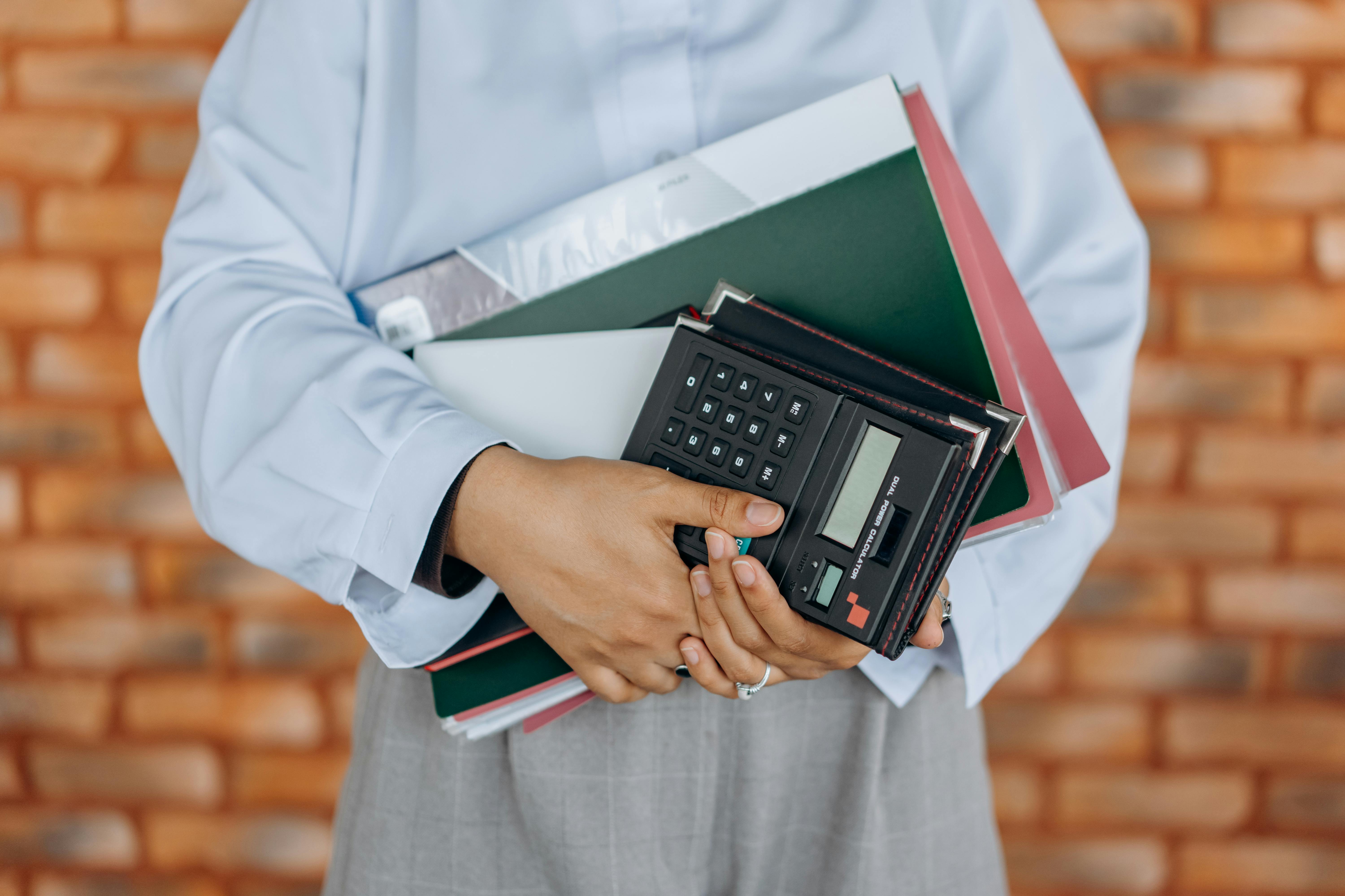 a person holding black calculator